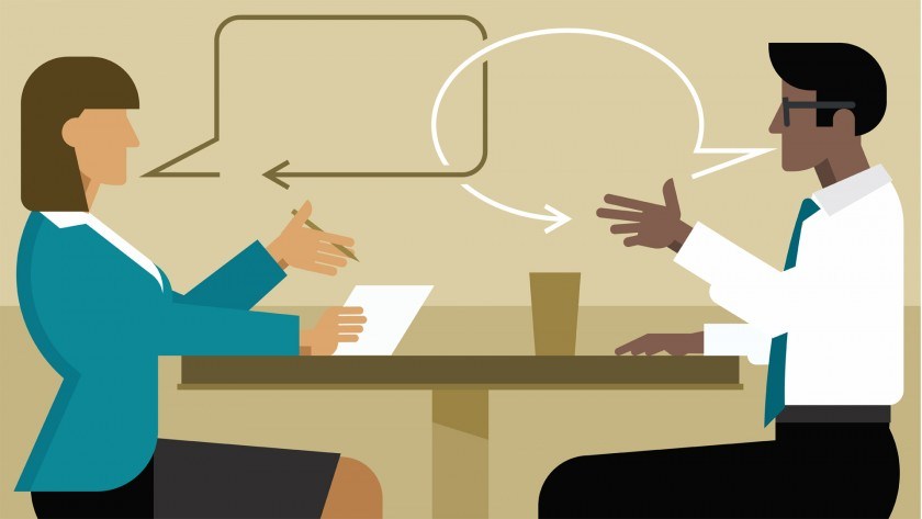 Illustration of 2 office workers at a table talking.